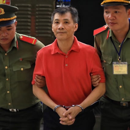 Michael Nguyen is escorted by policemen before his trial in Ho Chi Minh City on June 24, 2019. Photo: Reuters
