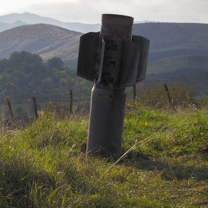 A tail of a multiple rocket 'Smerch' sticks out of the ground near the town of Martuni, the separatist region of Nagorno-Karabakh. Photo: AP