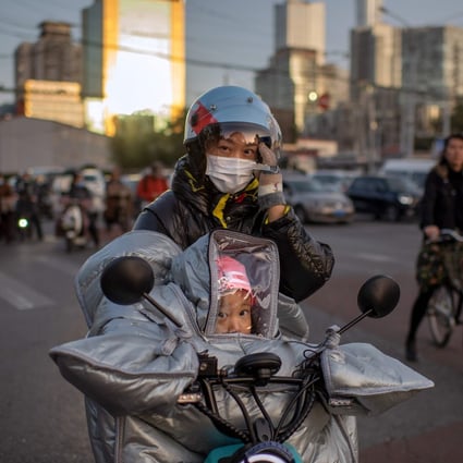 A woman and a child in protective gear ride an electric bike during rush hour in Beijing. China’s recovery from the pandemic has not eliminated the uncertainties surrounding its growth outlook. Photo: AFP