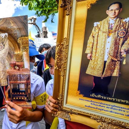 Demonstrators hold portraits of Thailand’s King Maha Vajiralongkorn (left) and his late father, king Bhumibol Adulyadej, during a rally demanding the protection of traditional Thai values, in Bangkok on July 30. Photo: AFP