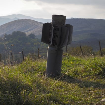 A tail of a multiple rocket 'Smerch' sticks out of the ground near the town of Martuni, the separatist region of Nagorno-Karabakh. Photo: AFP