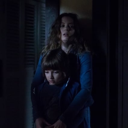 Azhy Robertson (front) and Gillian Jacobs in a scene from Come Play (category: IIA), directed by Jacob Chase and co-starring John Gallagher Jnr. Photo: Jasper Savage/Amblin Partners/Focus Features