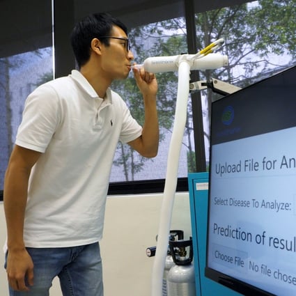 A member of staff demonstrates the breathalyser test kit developed by Breathonix at its laboratory in Singapore on Thursday. Photo: Reuters