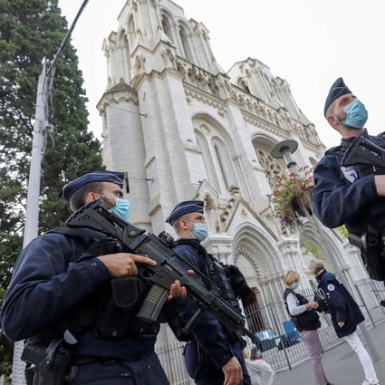 Police officers stand guard by the Notre-Dame basilica in Nice. Photo: AFP