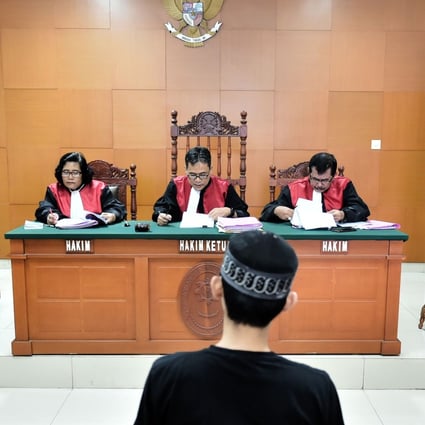 A suspected terrorist appears in court. Indonesia needs a stronger national effort to profile former extremists to persuade potential recruits to pause and think again before joining the cause. Photo: AFP