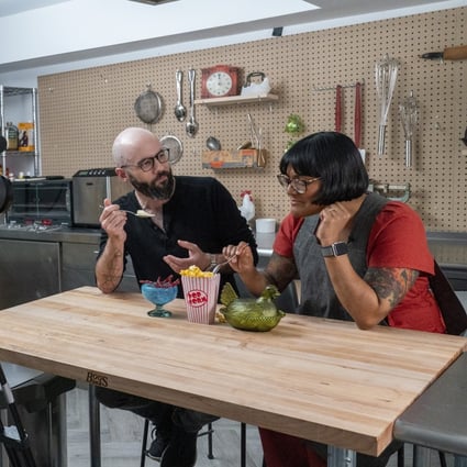 Andrew Rea, founder of the Binging with Babish network, tastes popcorn ice cream created by chef Sohla El-Waylly. Photo: AP/Mary Altaffer
