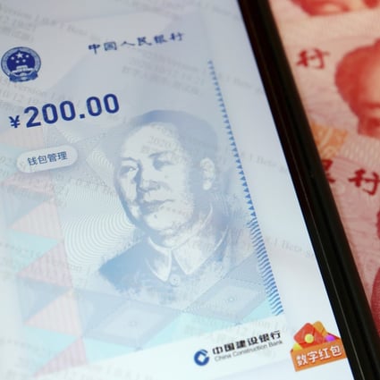 China's official app for its digital yuan is seen displayed on a smartphone next to 100-yuan banknotes on October 16. Photo: Reuters