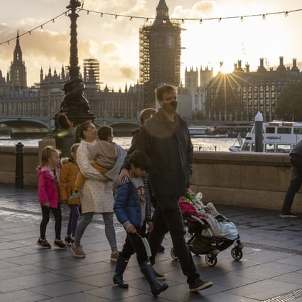 People walk along the River Thames in London, a day after Britain announced a month-long lockdown to quell a resurgence of coronavirus infections. Photo: Xinhua