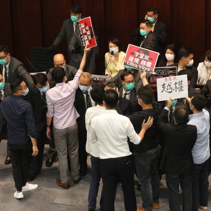 Lawmakers protest during a House Committee meeting at Legco in May, calling for pro-government lawmaker Starry Lee (seated, in yellow coat) to step down. Photo: Dickson Lee