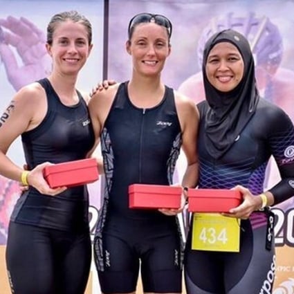 Nur Syahariah Jusoh (right) with fellow athletes at the 2019 Ironman Triathlon race wearing a sports hijab.