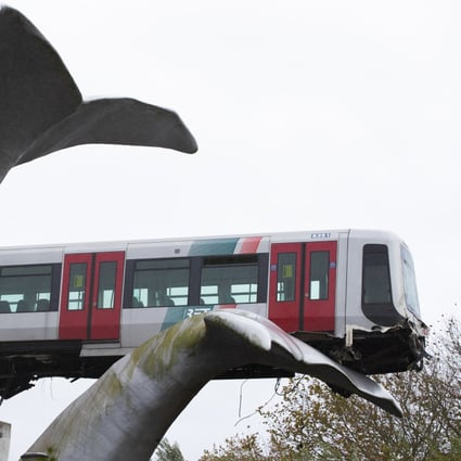 A whale tail sculpture caught the front carriage of a metro train as it rammed through the end of an elevated section of rails in the Netherlands. Photo: AP