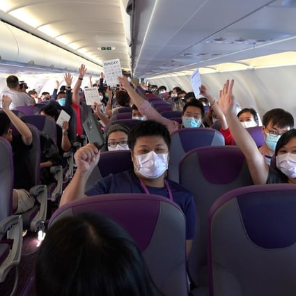 Passengers on board the HK Express flight play a game with crew members. Photo: Handout