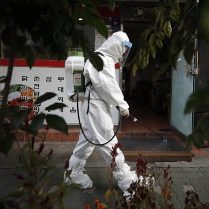 A worker sprays disinfectant to help curb the spread of the coronavirus in Seoul. Photo: AP
