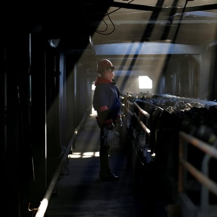 A worker inspects a conveyor belt carrying coal at a coal coking plant in Yuncheng in China’s Shanxi province on January 31, 2018. Photo: Reuters