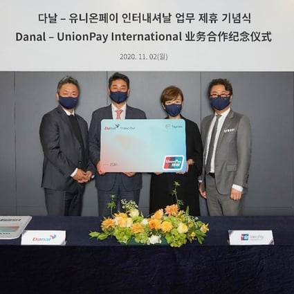 Executives from China's UnionPay and Korean payment firm Danal ink the deal for a prepaid card that accepts cryptocurrency. Photo: Handout