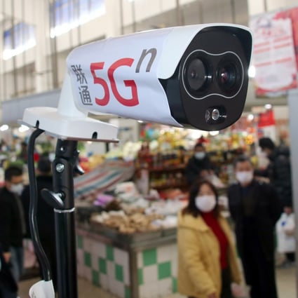 A new thermal temperature detector using 5G scans customers at a market in Suzhou, in China’s Jiangsu province, on February 20. When these devices detect anyone with a high temperature, they send out warning signals and identify the person using facial recognition technology. Photo: Imaginechina