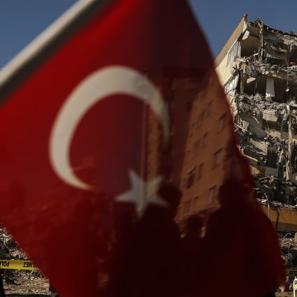 A building that was damaged in the earthquake on October 30 is demolished in Izmir, Turkey on Wednesday. Photo: AP
