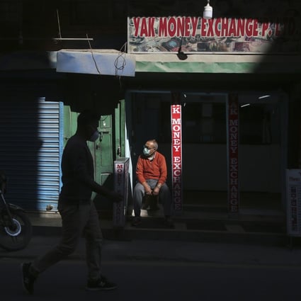 Business is hard to come by for a money changer in Kathmandu, Nepal. Photo: Niranjan Shrestha/AP