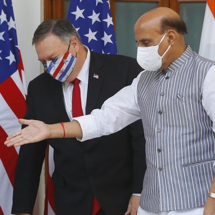 Indian Defence Minister Rajnath Singh (centre) gestures towards US Secretary of State Mike Pompeo. Photo: AP