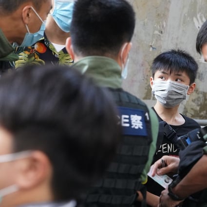 Police officers carry out an ID check on a boy outside Prince Edward MTR station on August 31, as anti-government protesters gathered to mark the first anniversary of the “831” incident. Photo: Winson Wong