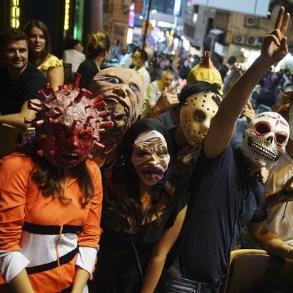 The crowds celebrate Halloween in Lan Kwai Fong, Hong Kong’s nightlife hub, on October 31. Pandemic fatigue and complacence already pose risks for fresh Covid-19 infections, and quarantine exemptions will only make matters worse. Photo: Winson Wong