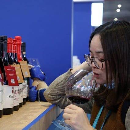 A woman samples red wine from Australia at the third annual China International Import Expo in Shanghai on Thursday. Photo: AFP