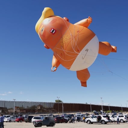 A "Baby Trump" balloon flies over the US-Mexico border fence in California as US President Donald Trump. The balloon may have inspired the Trump the Baby nickname sometimes employed by Chinese internet users to describe the American president. Photo: Reuters