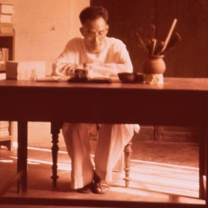 Chinese scholar Xu Fancheng pictured sat at a desk in his house in Pondicherry. Photo: Handout / Xu Fancheng Culture Study Centre