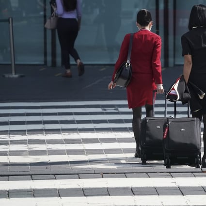 Cathay Pacific employees wheel their luggage towards the company’s headquarters at Chek Lap Kok on October 21. Photo: Felix Wong