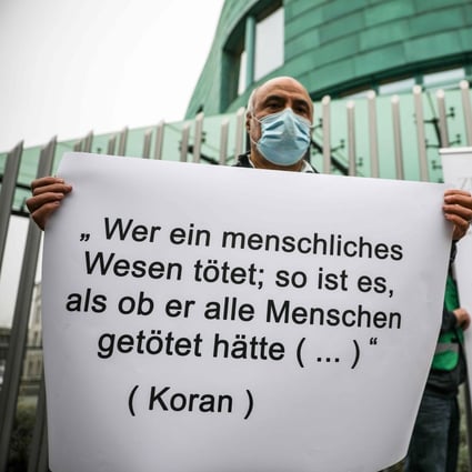 A placard with a verse from the Koran reading “Whoever kills a human being, it is as though he had killed all mankind …” during a vigil outside the Austrian embassy in Berlin on Friday. Photo: AFP