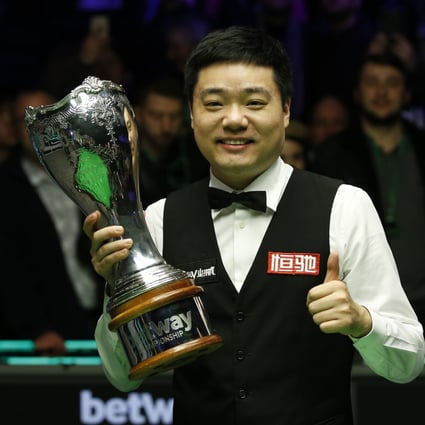 China’s Ding Junhui holds the trophy after winning the 2019 UK Championship with victory over Stephen Maguire in the final. Photo: Xinhua