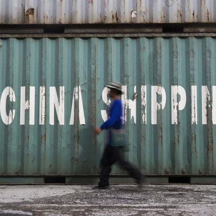 A worker passes a China Shipping Group container at a depot in Bangkok, Thailand. Photo: Bloomberg