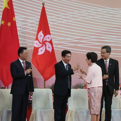 Luo Huining, director of the liaison office, clinks glasses with Carrie Lam as Chen Daoxiang (left), head of the PLA Hong Kong garrison, Xie Feng, the foreign ministry‘s representative in the city, and former chief executive Leung Chun-ying look on during the flag-raising ceremony on the 23rd anniversary of the establishment of the Hong Kong special administrative region, at Golden Bauhinia Square in Wan Chai on July 1. Photo: K.Y. Cheng