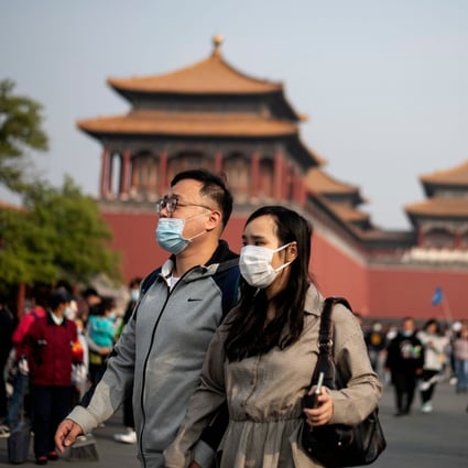 People wearing face masks walk outside Beijing’s Forbidden City during the country's ‘golden week’, on October 8. Photo: AFP
