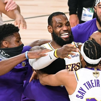 Los Angeles Lakers players including LeBron James (centre) celebrate winning the 2020 NBA Championship after defeating the Miami Heat. James has indicated the team will visit the White House under Joe Biden. Photo: Wally Skalij/Los Angeles Times/TNS