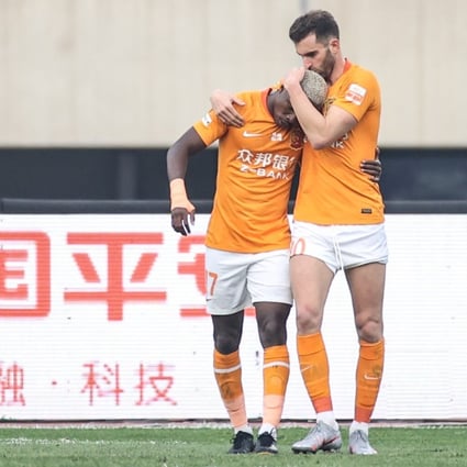 Wuhan’s Jean Evrard Kouassi (left) celebrates his goal with Leo Baptistao in their Chinese Super League match against Shijiazhuang Ever Bright in Dalian. Photo: Xinhua