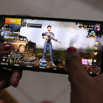 A woman plays PUBG Mobile on her smartphone in New Delhi on September 2. Photo: EPA-EFE