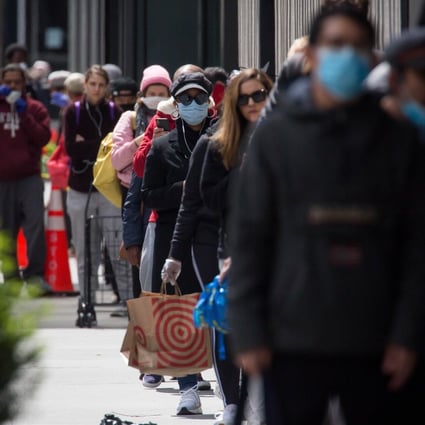 People wearing face masks queue outside a shop amid the coronavirus pandemic in New York earlier this year. Photo: Xinhua