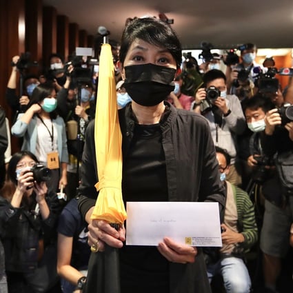 Hong Kong opposition lawmaker Claudia Mo holds a yellow umbrella on her way to hand in her resignation letter in protest over the disqualification of four legislators by China’s National People’s Congress Standing Committee. Photo: dpa