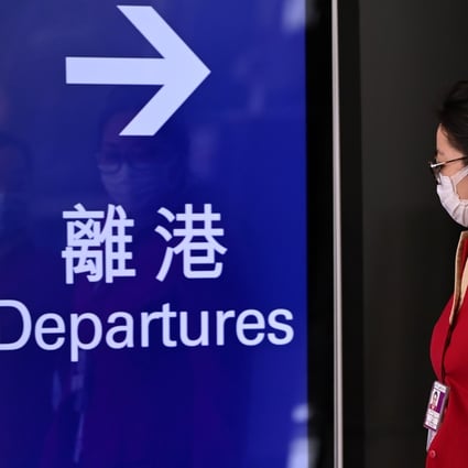 Cathay Pacific employees walk through Hong Kong International Airport on October 21 as the flagship carrier announces mass lay-offs. Photo: AFP