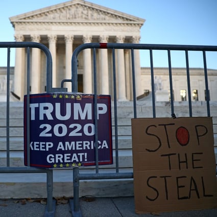 Signs put up by supporters of US President Donald Trump hang outside the Supreme Court building in Washington on November 10. Photo: Reuters