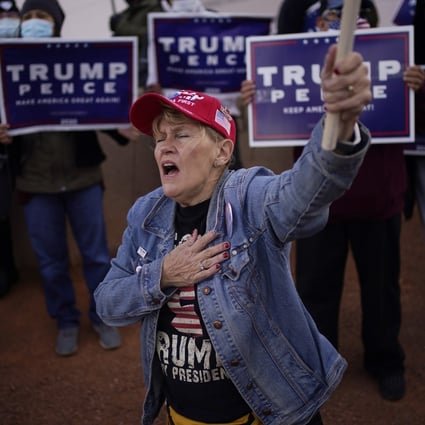 A supporter of US President Donald Trump holds her hand over her heart during a protest of the election outside of the Clark County Election Department in Las Vegas on November 8. Photo: AP