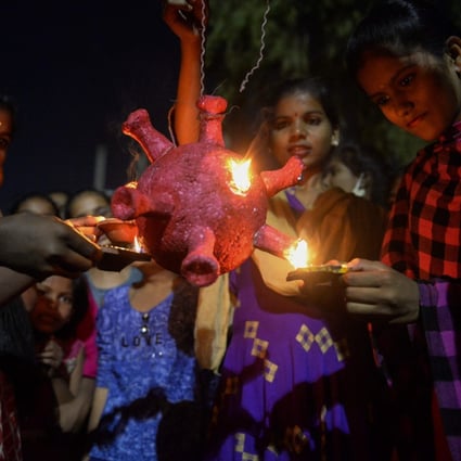 Students prepare to burn a coronavirus model during Diwali, the Hindu Festival of Lights, in Hyderabad, India, on Saturday. Photo: AFP