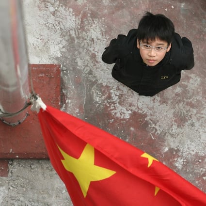 (Left to right) Chan Kai-shing and Li Sui-hung, students of St. Bonaventure Catholic Primary School, practise raising the national flag as part of the school's patriotic education activities. St. Bonaventure Catholic Primary School, Diamond Hill. Photo: File
