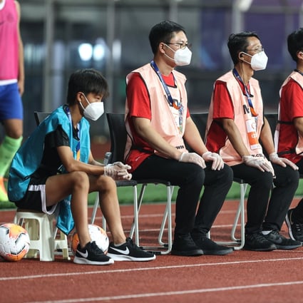 Staff members wearing masks at the opening Chinese Super League match between Wuhan Zall and Qingdao Huanghai in Suzhou in July. Photo: Xinhua