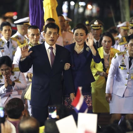 Thai King Maha Vajiralongkorn, left and Queen Suthida, right, wave to supporters in Bangkok, Thailand on Saturday. Photo: AP