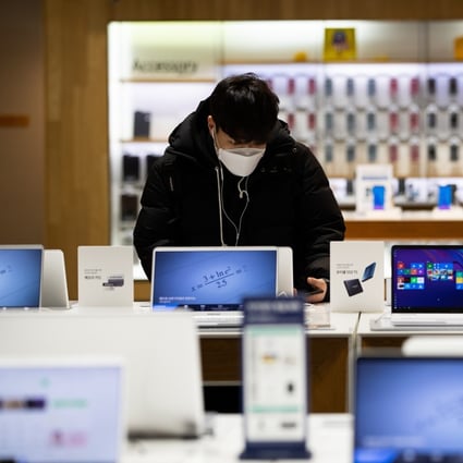A customer looks at Samsung Electronics laptop computers at the company's flagship store in Seoul, South Korea. Global PC shipments in the third quarter were up 14.6 per cent year on year to 81.3 million units, according to IDC. Photo: Bloomberg