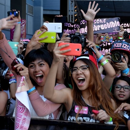 American fans of Korean K-pop group Girl's Generation scream as they appear on the red carpet during K-CON 2014 at the Los Angeles Memorial Sports Arena. The group’s fandom, Sone, is one of many whose members obsessively follow K-pop idols. Photo: AFP