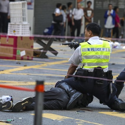 Police officers subdue protesters blocking a road crossing in Sai Wan Ho on November 11, 2019. Photo: Nora Tam