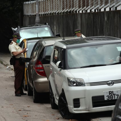 Traffic wardens give out tickets to illegally parked cars in Shau Kei Wan on March 27. Photo: Xiaomei Chen